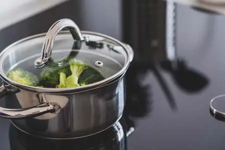 Man cooking in stainless steel stockpot