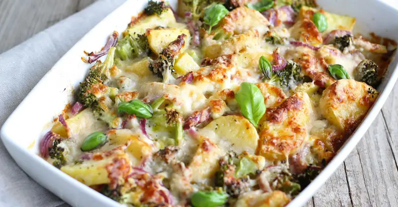 Image is a close-up of a cheesy broccoli and potato casserole.