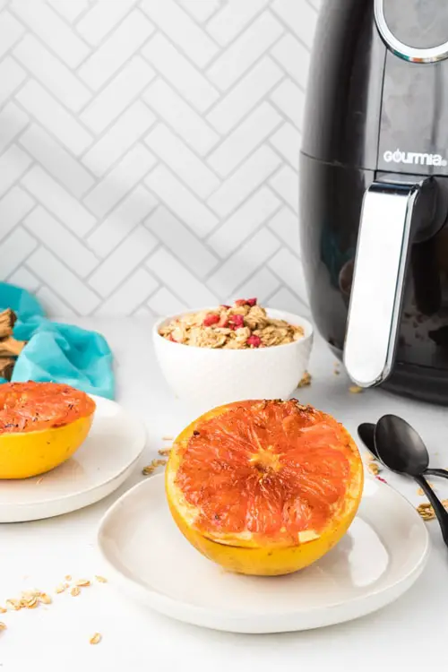 Air fryer with granola and dried out grapefruit laid out in front