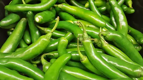 A bunch of green serrano peppers