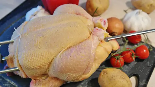 Whole raw chicken prepared for roasting