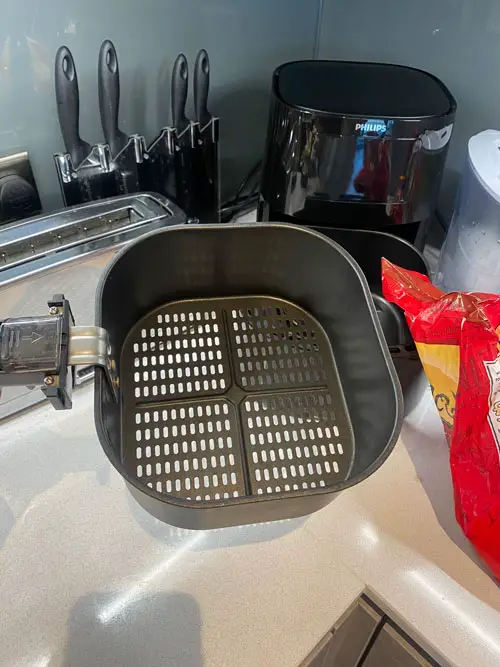 Overhead of the Philips air fryer basket, taken outside of the main air fryer chamber