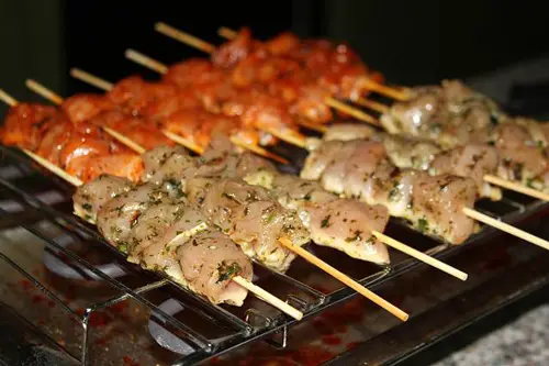Skewered chicken cuts marinated with different ingredients
