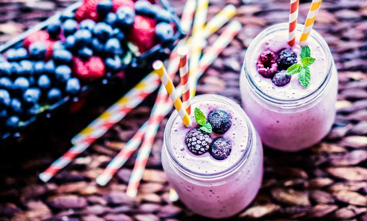Blueberry smoothie with blueberries and straws